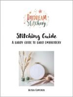 Cover of Stitching Guide by Alisia Cameron, featuring an embroidery hoop, wool, a Buddhist hand embroidery design, and vases with dried flowers displayed on a table.