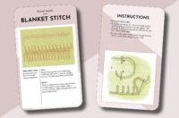 The Essential Embroidery Stitches Card Deck by Betty Barnden includes two cards depicting the blanket stitch with green thread on tan fabric, clear step-by-step diagrams, written instructions, and a soft pink background.