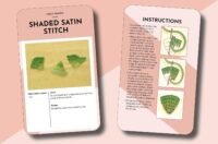 The Essential Embroidery Stitches Card Deck by Betty Barnden includes two cards on shaded satin stitch: one with green stitched shapes on yellow fabric, and another with step-by-step diagrams and instructions. Both feature pink borders.