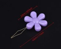 A pack of 20 purple flower-shaped needle threaders, each with a thin wire loop and measuring 4.5 cm wide by 2.5 cm tall, is displayed on a black background.