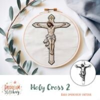 An embroidery hoop shows a stitched image of Jesus on the cross with greenery and grey cloth. Text reads "Holy Cross 1: Hand embroidery pattern (Copy)" and features the Daydream Stitchery logo.