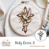 An embroidery hoop features a hand-stitched white dove before a cross with gold rays and a ribbon. At the bottom, it reads Daydream Stitchery – Holy Cross 2: Hand embroidery pattern (Copy).