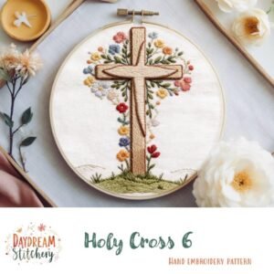 An embroidered cross with colourful flowers in a wooden hoop, shown on light fabric with embroidery tools nearby. Text displays “Holy Cross 6: Hand embroidery pattern.”.