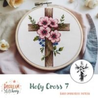 The Holy Cross 7: Hand embroidery pattern by Daydream Stitchery features a wooden cross framed in an embroidery hoop, adorned with pink and red flowers and green leaves for a beautiful, faith-inspired design.