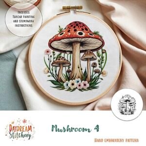 Embroidery hoop with a detailed hand embroidery pattern of three large red mushrooms with white spots, green leaves, and pink and white flowers. Text: “Mushroom 4a: PDF hand embroidery pattern.”.