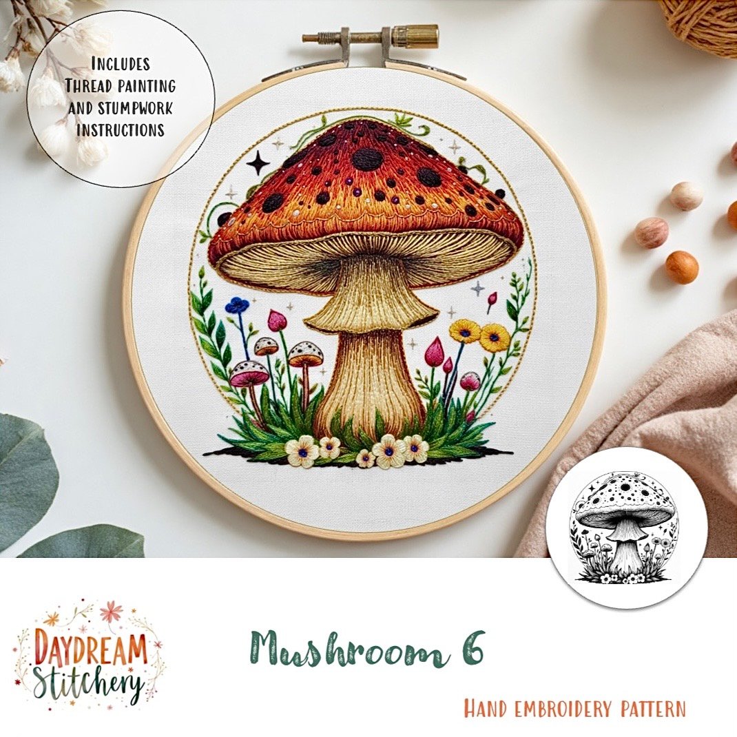 A hand embroidery hoop displays a detailed red and brown mushroom with grass, flowers, and colourful accents. The text reads "Mushroom 6a: Hand embroidery pattern" by Daydream Stitchery.