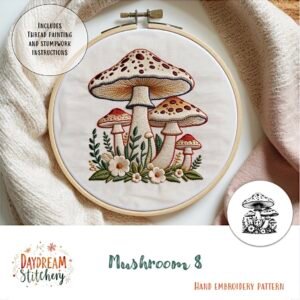 The Mushroom 8: Hand embroidery pattern features five red and beige mushrooms with green leaves and white flowers, created by Daydream Stitchery.