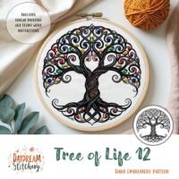 A vibrant embroidered Tree of Life with swirling branches and roots is framed in a wooden hoop, surrounded by yarn, scissors, and leaves. Text: “Tree of Life 12: Hand embroidery pattern” by Daydream Stitchery—a unique design.